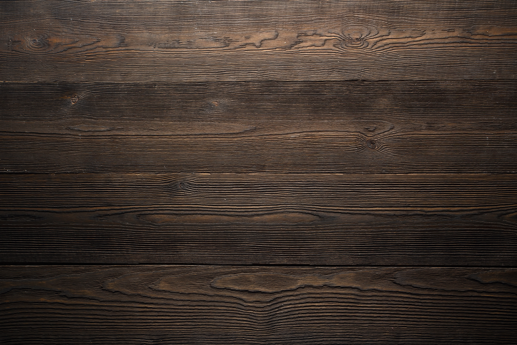 Dark wood surface with a few cracks Dark wood surface with a few cracks