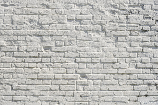 White brick wall with black spots
