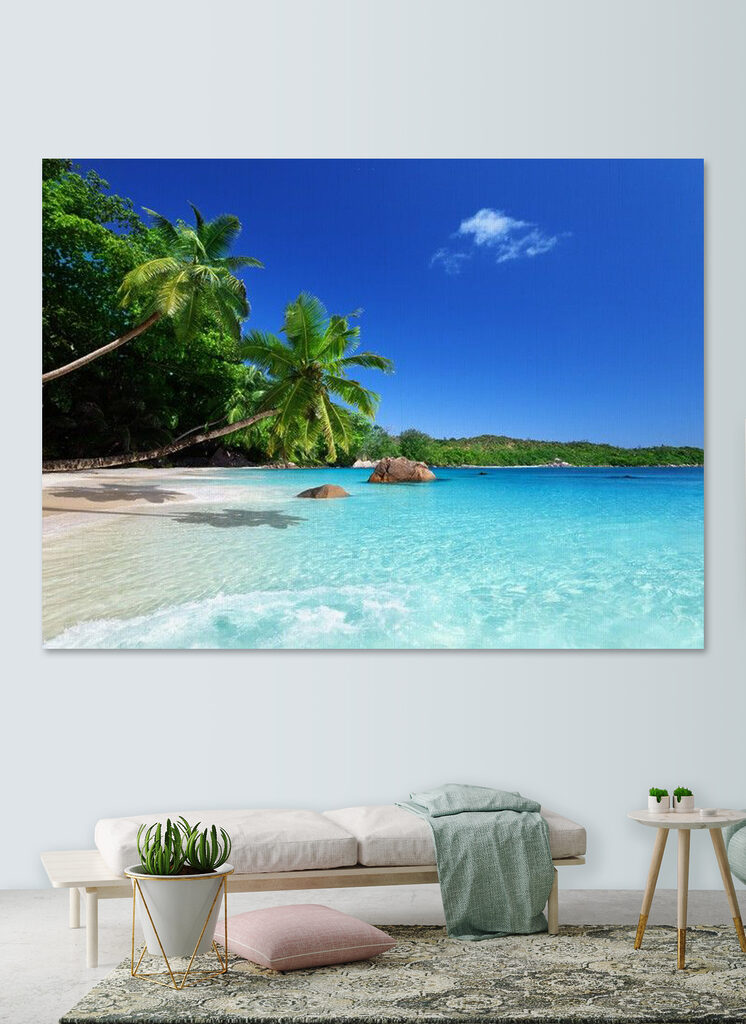 A beach with palm trees and blue water
