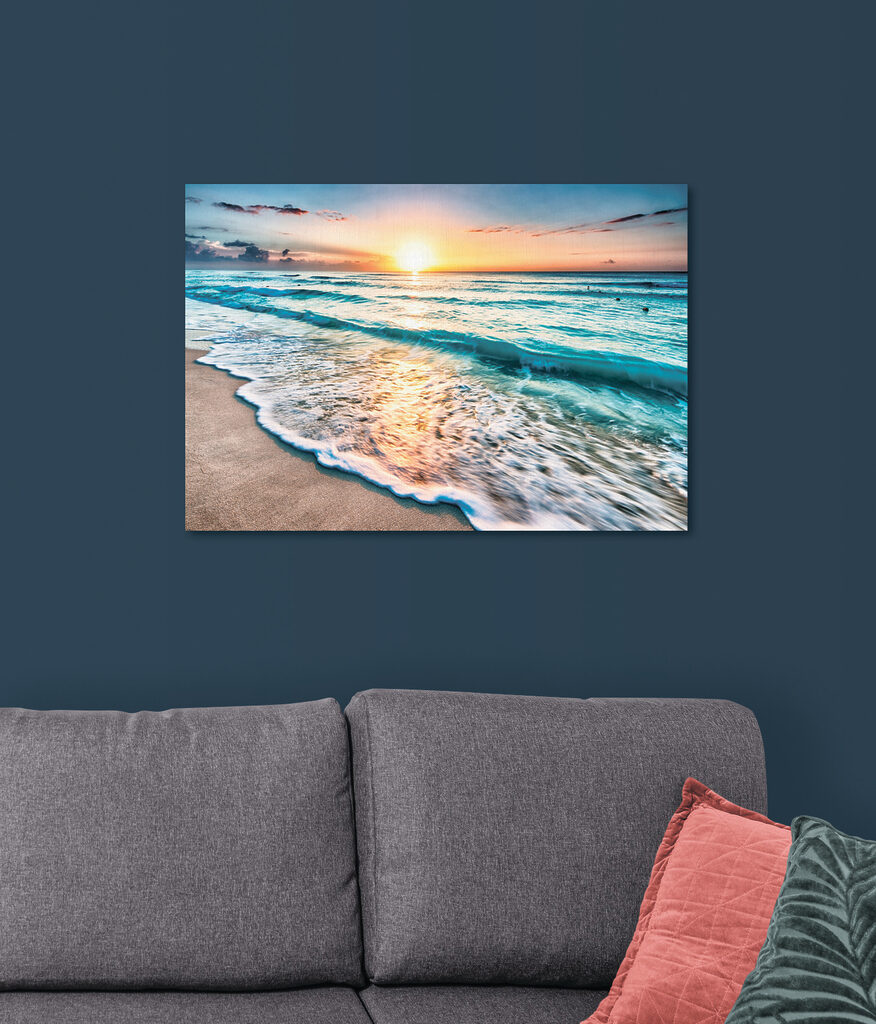 A beach with waves and a sunset