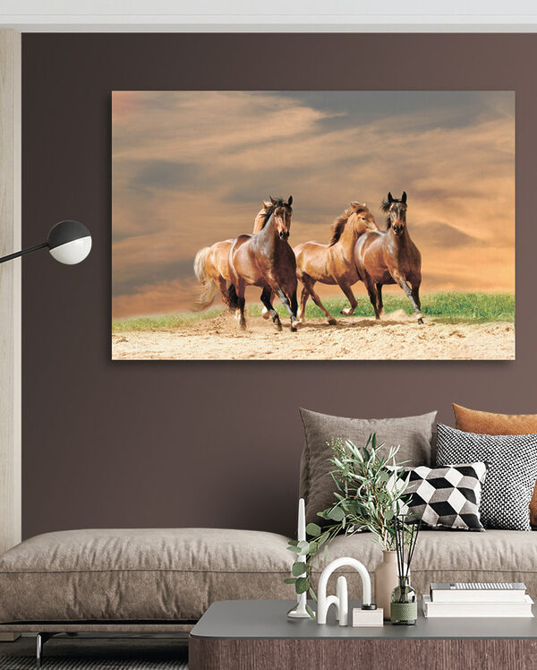 A group of horses running on a dirt road A group of horses running on a dirt road