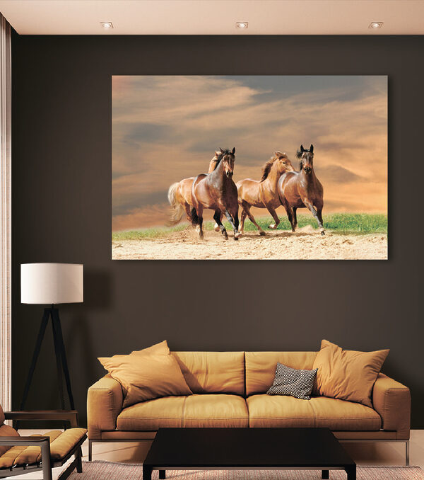 A group of horses running on a dirt road A group of horses running on a dirt road