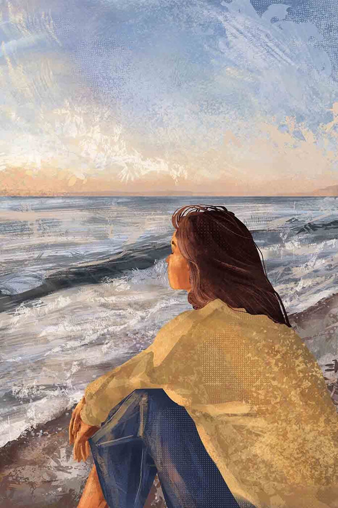 A woman sitting on a beach looking out to the ocean A woman sitting on a beach looking out to the ocean