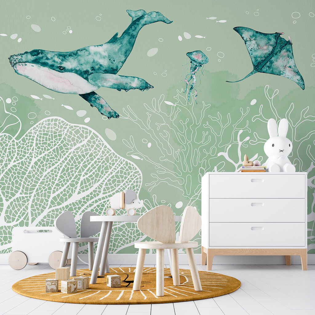 A whale and stingrays swimming in the ocean
