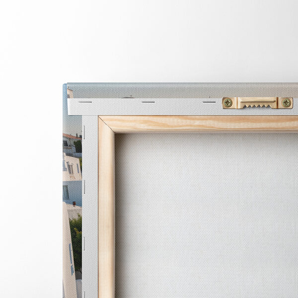 White buildings with blue domes on a hill with a body of water in the background