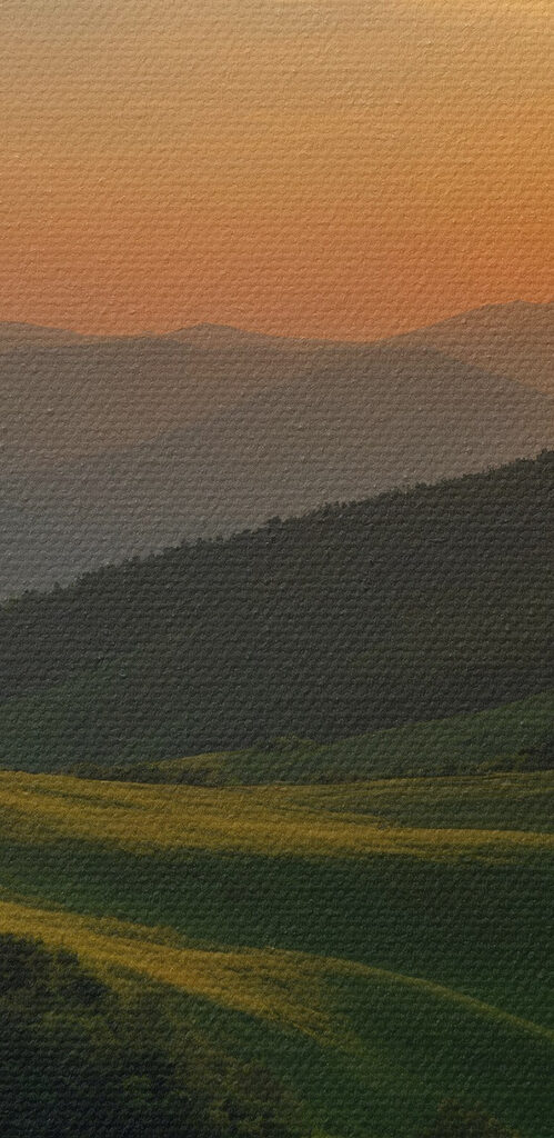Sunset over a green hill