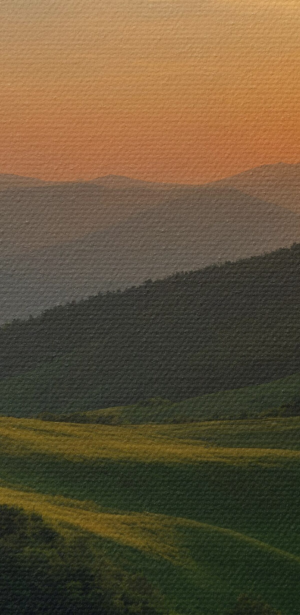 Sunset over a green hill