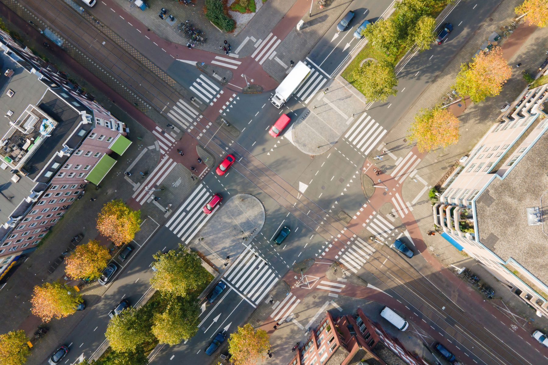 Aerial view of a street intersection with cars and buildings Aerial view of a street intersection with cars and buildings