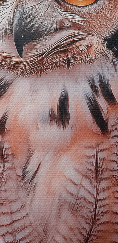 An owl in a tree with pink flowers