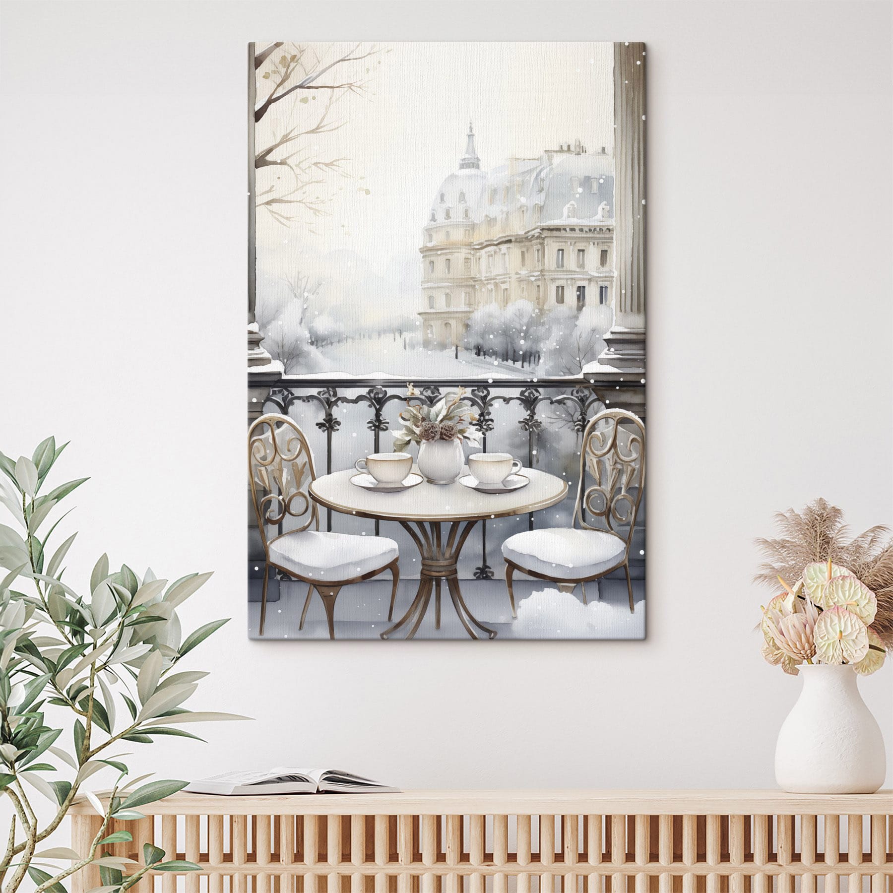 Table with cups and a vase of flowers on it with a snowy landscape