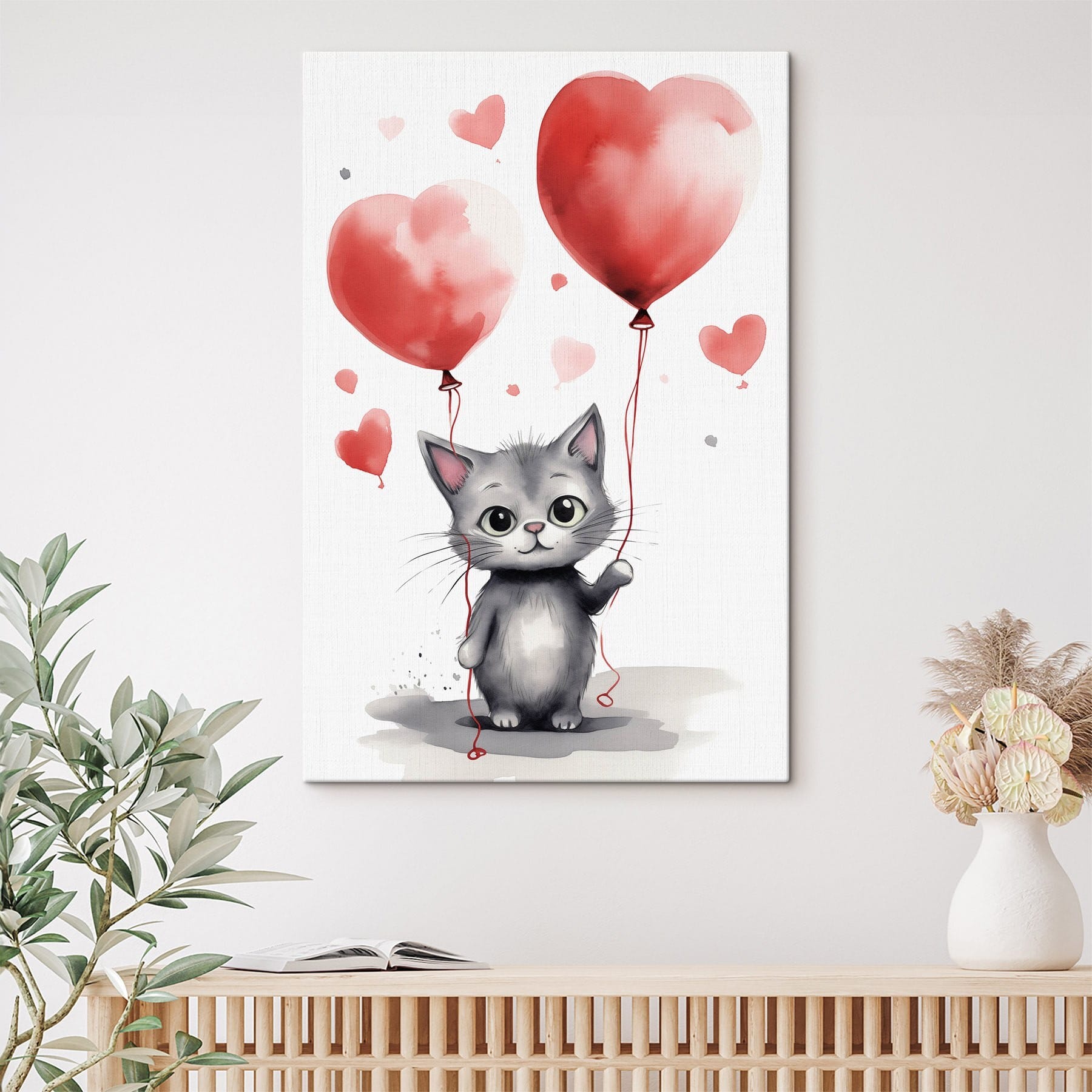 Cat holding balloons