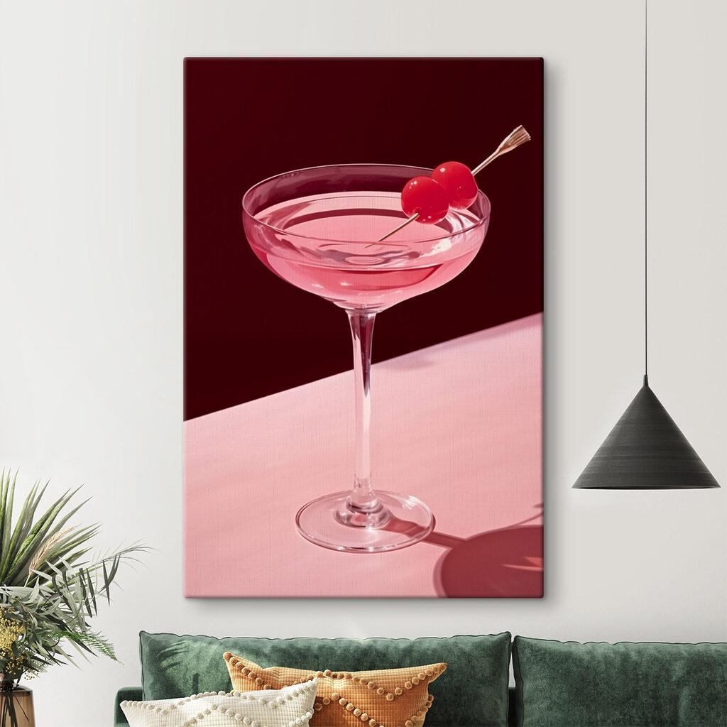 Glass with pink liquid and two cherries on it