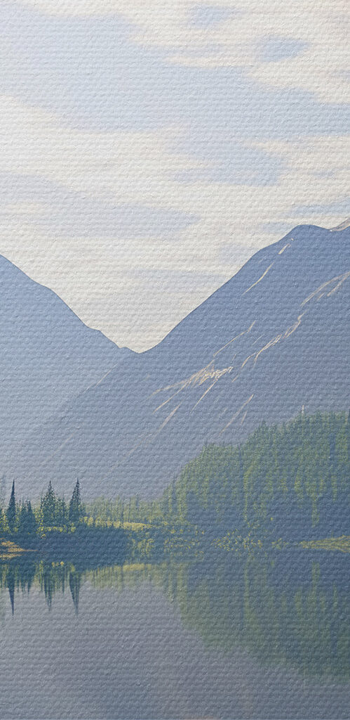 Lake with trees and mountains in the background