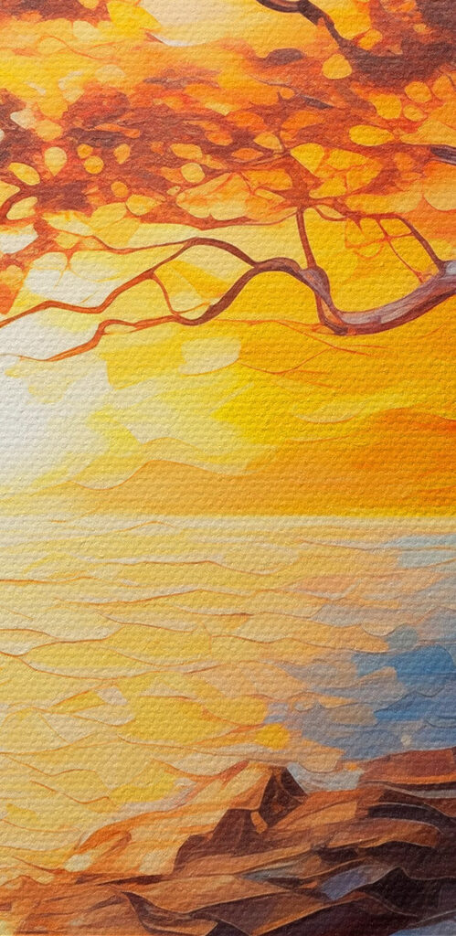 Tree on a rocky shore with a sunset behind it