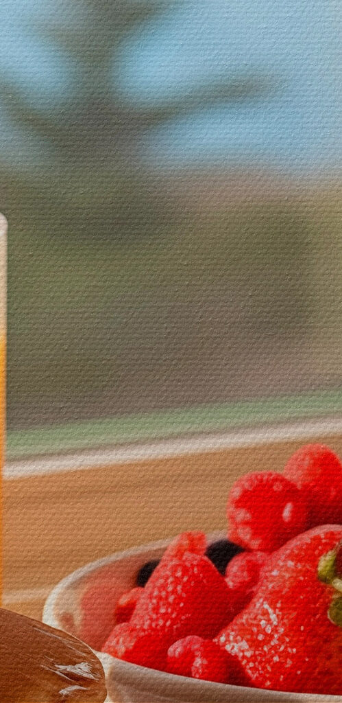 Stack of pancakes with berries and a glass of juice on a table