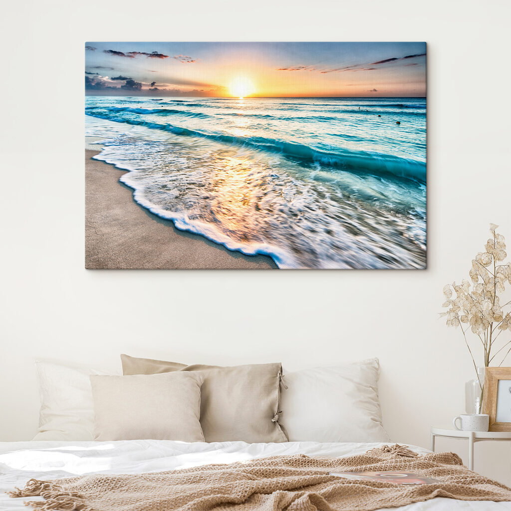 A beach with waves and a sunset