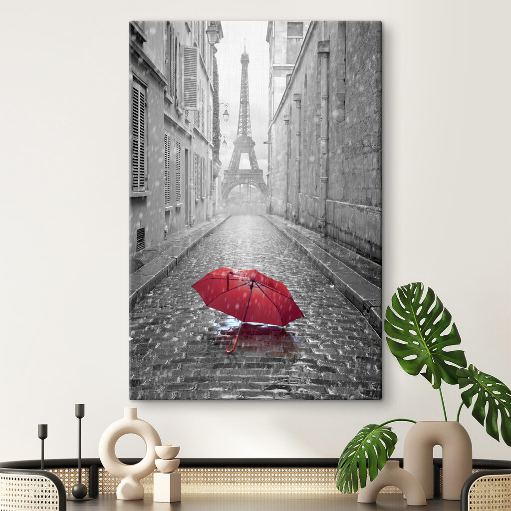 A red umbrella in a street with a tower in the background A red umbrella in a street with a tower in the background