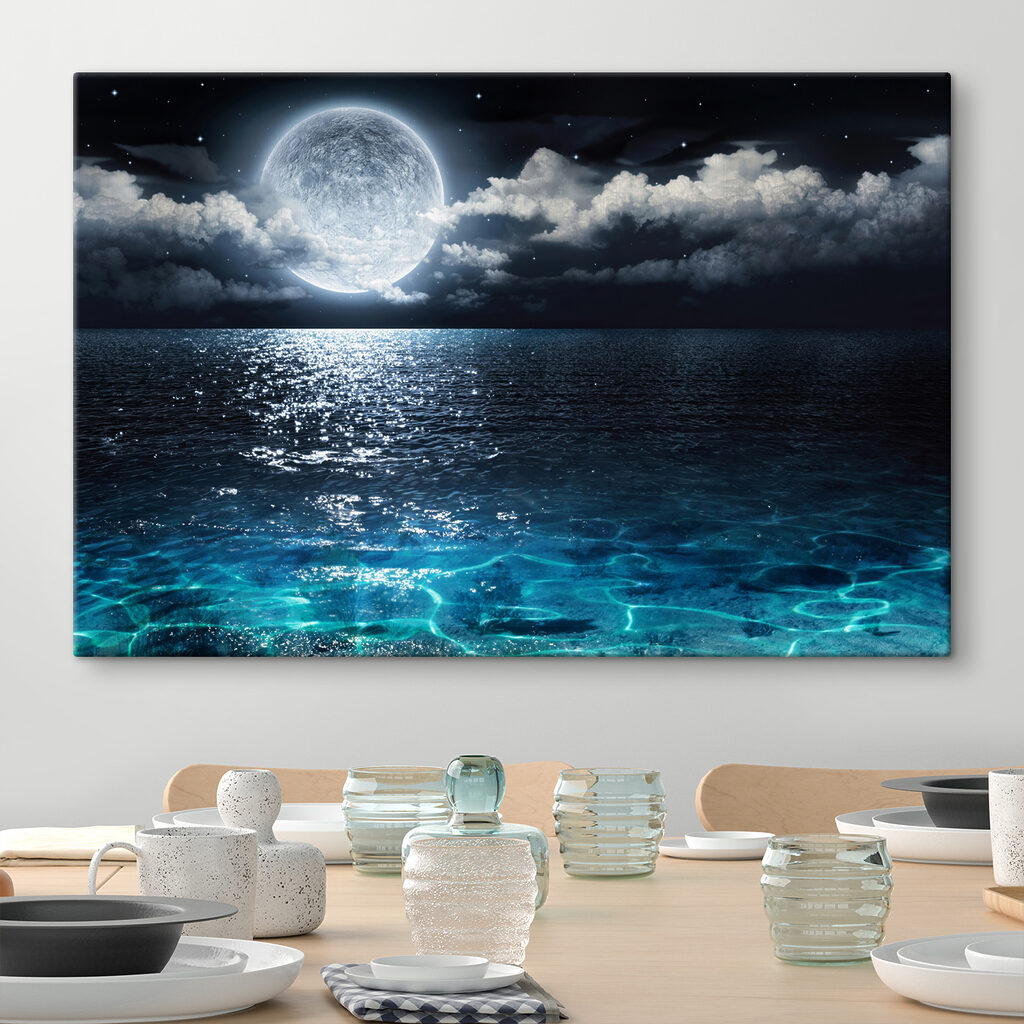 A moon over water at night
