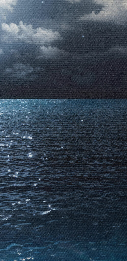 A moon over water at night