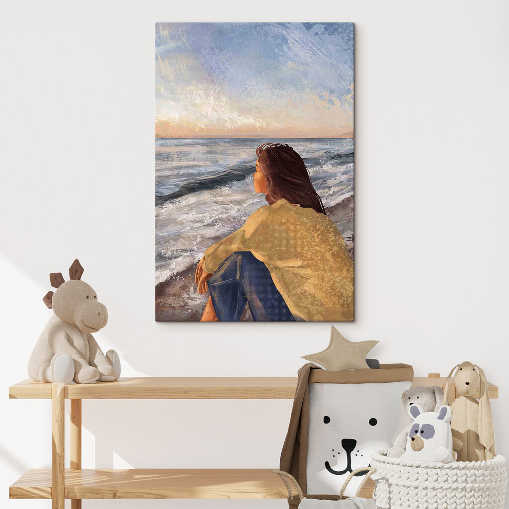 A woman sitting on a beach looking out to the ocean A woman sitting on a beach looking out to the ocean