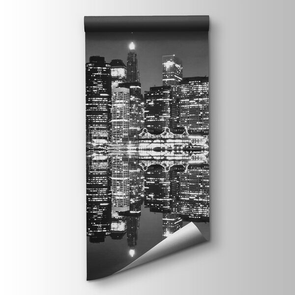 City skyline at night with lights reflecting on water