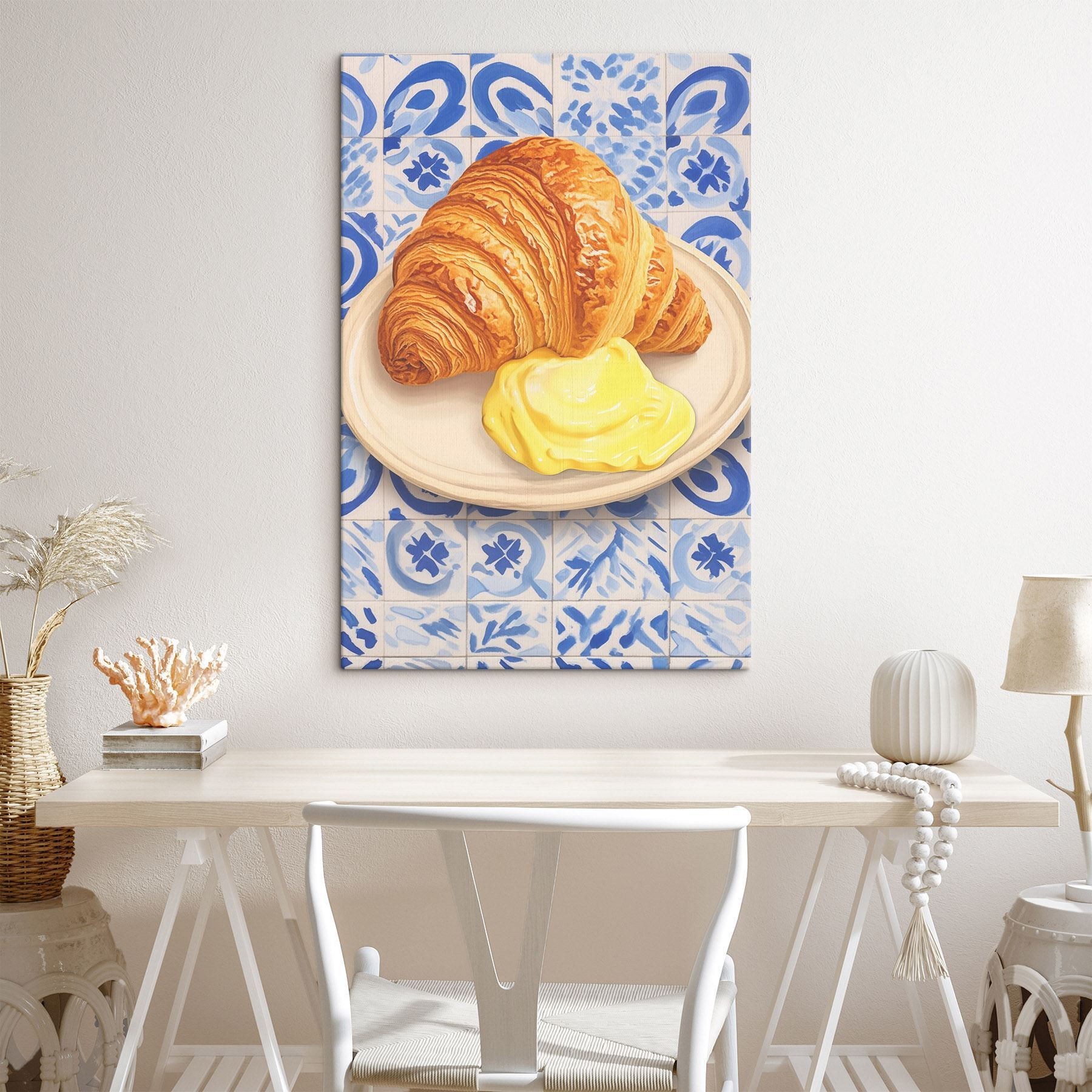 Croissant and a yellow liquid on a plate