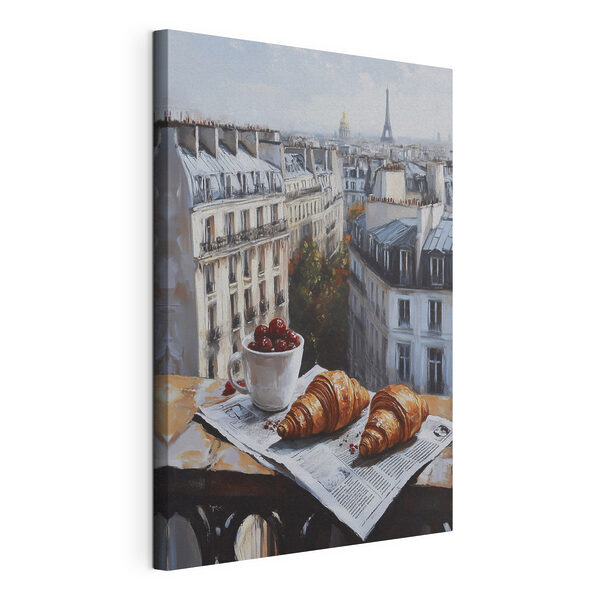 Vászonképek Egy csésze kávé és croissant egy asztalon, a háttérben épületekkel